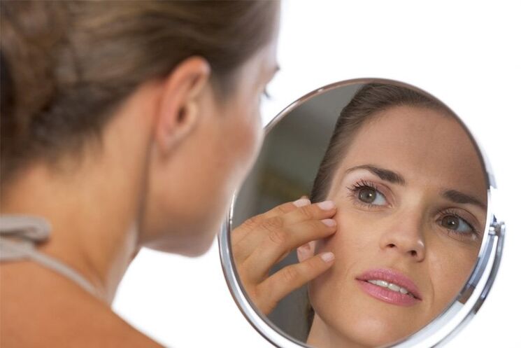 girl looks in the mirror for skin rejuvenation